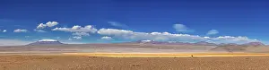 Panorama: Panorama of a vast desert plain with a majestic mountain panorama under a clear sky
