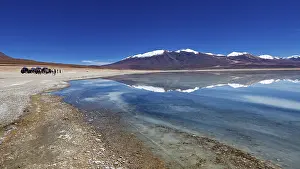 Vehicles: Panoramic view of a lake with snow-capped peaks