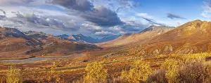 Roads: Panoramic view of mountains and the North Klondike river in autumn with golden foliage under a dynamic sky