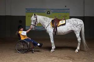 Saddle: Paraplegic woman and horse in a horse therapy center