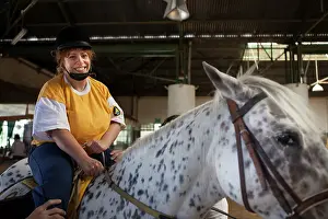 Saddle: Paraplegic woman on horse in a horse therapy center