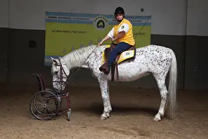 Saddle: Paraplegic woman on horse in a horse therapy center