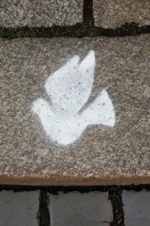 Bartruff: Peace dove symbol in cobblestone sidewalk