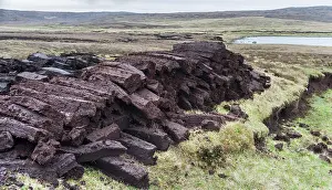 Warmth: Peat cutting on Shetland, Scotland. the