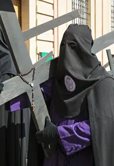 Crosses: Penitent with cross and rosary at the Semana