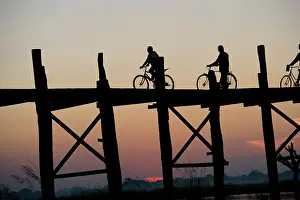 Bicycle: People cycling through U Bein's Bridge leading