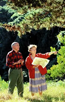 Walkers: People - man and woman walking, studying map