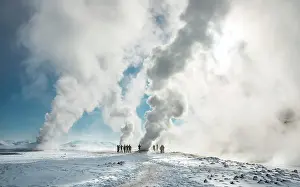 Fumarole: People standing by a fumarole, rising steam, geothermal