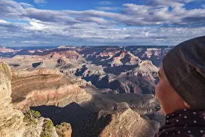 Landmarks: Person admiring sunlight and shadows in the Grand Canyon