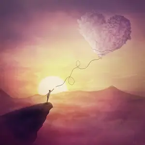 Loneliness: A person on the cliff and a heart shaped cloud like