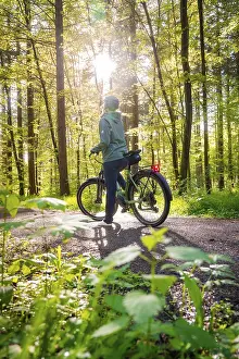 Bicycle: A person stops on a bicycle, sunbeams penetrate