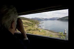 Binoculars: PERSON watching with binoculars in otter hide