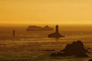 Ship: Phare de la Vieille lighthouse and ferryboat at sunset