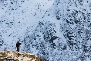 Svolvaer: Photographer on a hill in the snow, Norway