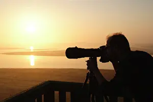 Oosterschelde: photographer watching over the saltmarsh with his camera