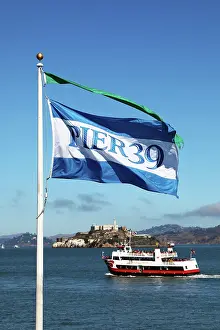Ferries: Pier 39 flag, sightseeing boat and Alcatraz prison