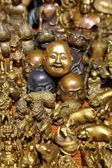Figurine: Pile of brass figures including laughing Buddha head in