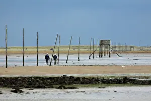 Pilgrim: Pilgrim's Way - two people walking over the mudflats