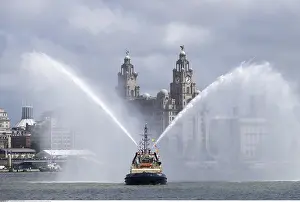 Ferry: Pilot boat spraying water with The Liver Building