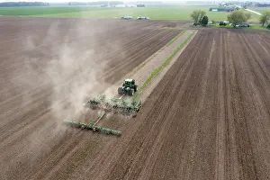Soil: Pinnebog, Michigan, A tractor plows a farm field