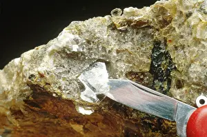 Mica: Pocket-knife cleaving a flake of mica
