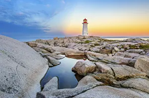 Tower: A pool of water in the rocks in front of the iconic lighthouse in Peggy's Cove