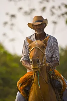 Headdresses: Portrait of a Pantaneiro riding a horse in Pantanal Brazil