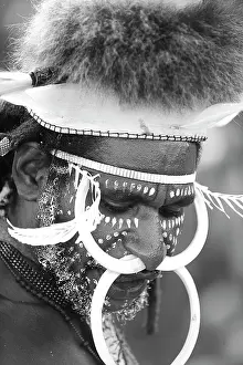 Facial: Portrait of a Papua Warrior wearing pig teeth and feathers o