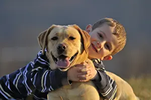 Wheedle: Portrait of a young boy and his Labrador dog