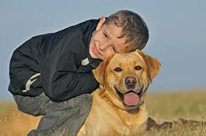 Wheedle: Portrait of a young boy and his Labrador dog