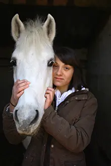 Smiles: Portrait of a young rider with his horse