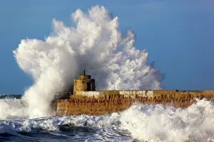 Piers: Portreath - wave breaks over pier in storm