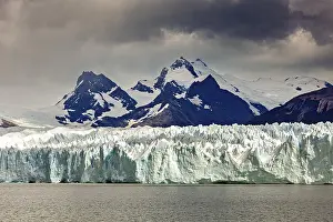 Glaciers: A powerful view of snow-covered mountains and glaciers under a gloomy sky