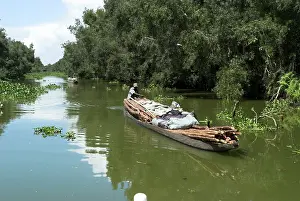Sell: Produce being transported on the river, by dugout