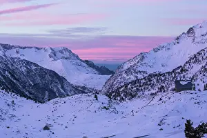 Sergio Arias: Pyrenees sunrise over snowy mountains with mountain lodge