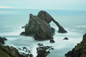 Butte: Quartzite sea arch at dusk, Bow Fiddle Rock, Portknockie