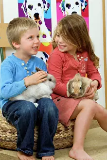Stroking: Rabbits - being cuddled by two young children