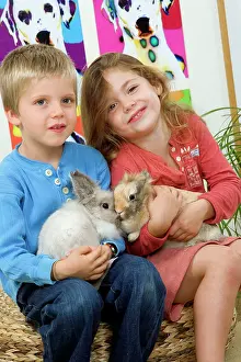 Stroking: Rabbits - being cuddled by two young children