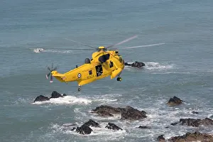 Rescues: RAF helicopter air sea rescue - hovering over rocks