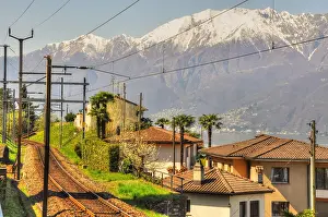 Tracks: Railroad Tracks and Snow-capped Mountain in Ticino