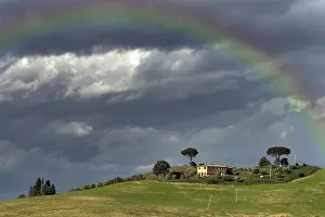 Gloomy: Rainbow over country house, Crete Senesi, Tuscany