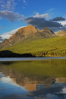 Rainbow: Rainbow Peak reflects in Bowman Lake in Glacier