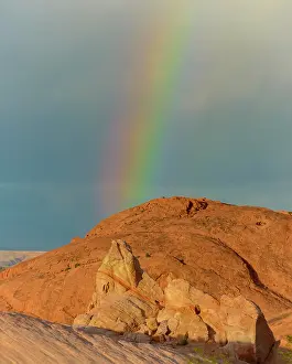 Prior: Rainbow over red rocks with passing storm