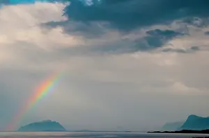 Runde: Rainbow over the shore of the west fjord, Norway