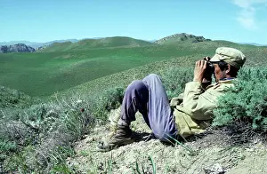 Binoculars: Ranger with binoculars - watching for Kopet Dag Arkal sheep
