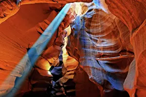 Falling: Rays of light falling on yellow-red sandstone formations