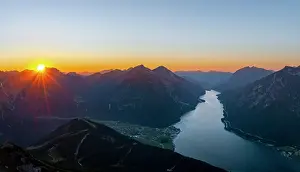 Rays: Last rays of sun over mountain landscape at sunset