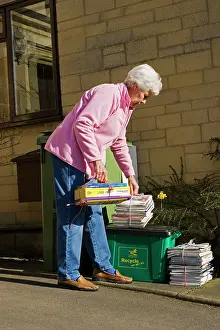 Bundles: Recycling - pensioner taking neatly tied bundles
