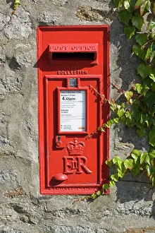 Letterbox: Red rectangluar Post Office box set in stone wall