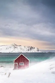 Cabin: Red Rorbuer fishing hut on the beach in the snow